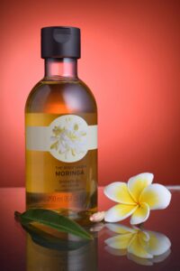 Moringa plant-infused shower gel with a floral accent, showcasing natural ingredients for a refreshing and nourishing skincare experience.